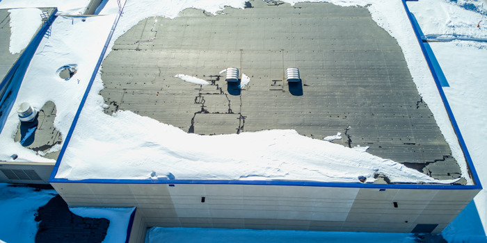 Building rooftop covered in snow