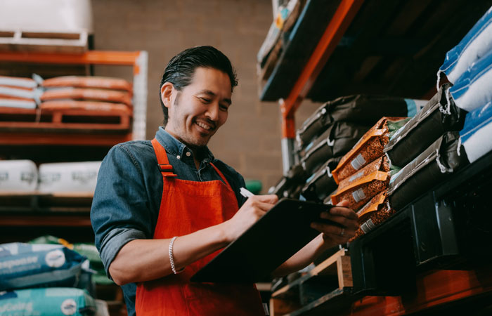 A man with a clipboard in a retail store