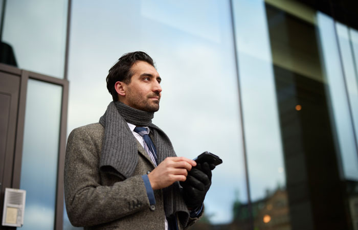 A business man standing outside an office