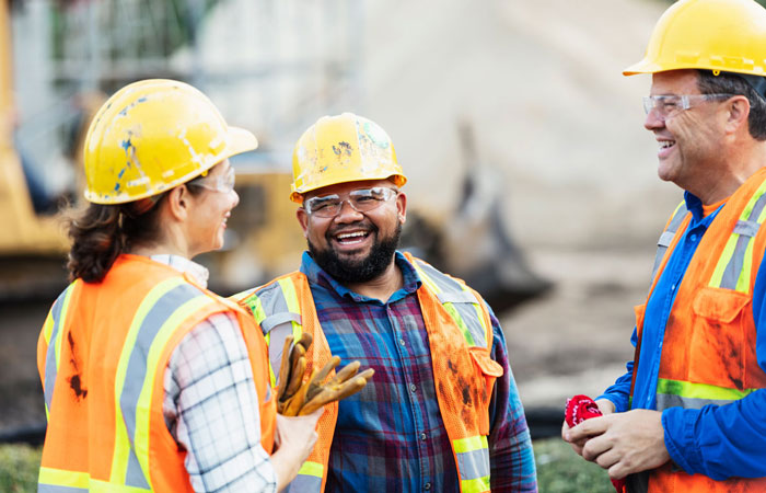 construction workers in hi-viz safety gear talking