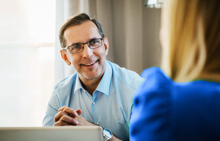 Two people looking over a document together