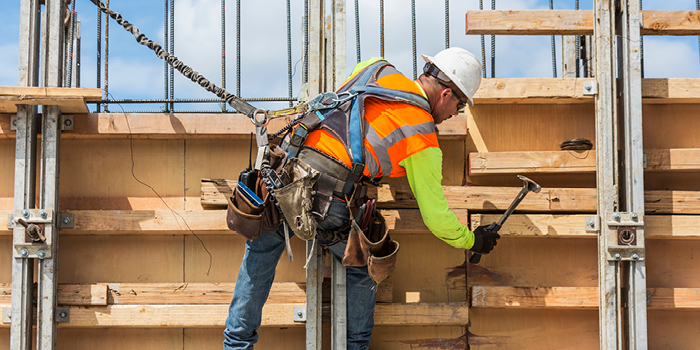 Construction worker hammering wood