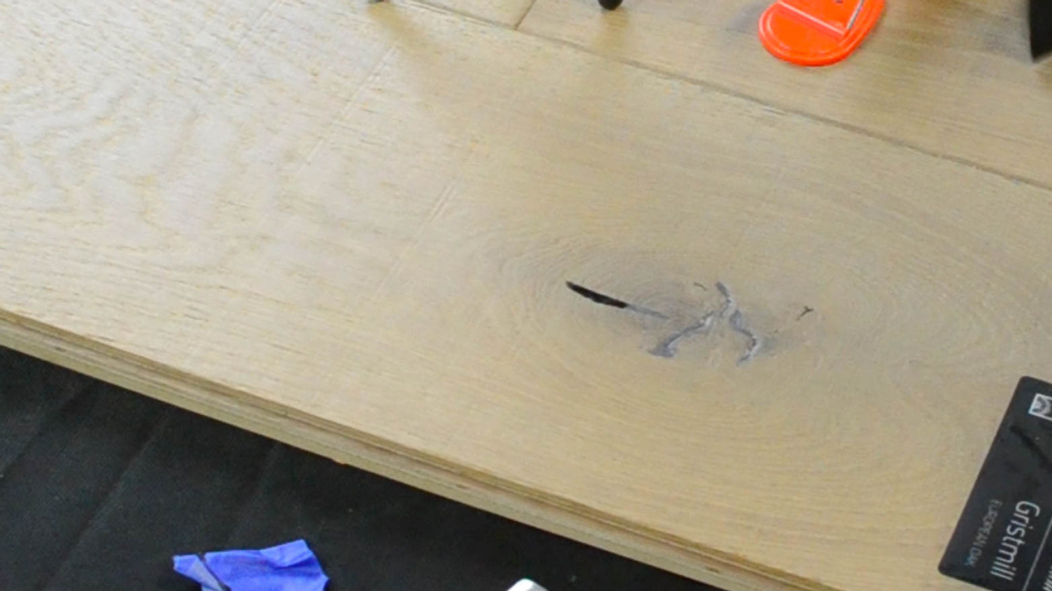 repairing a wood floor knot with wax