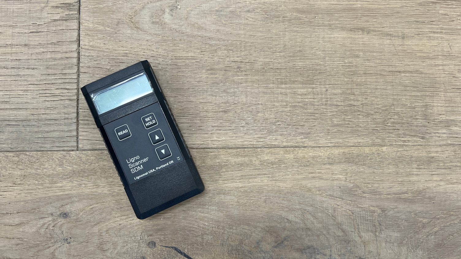 Moisture meter on a hardwood floor