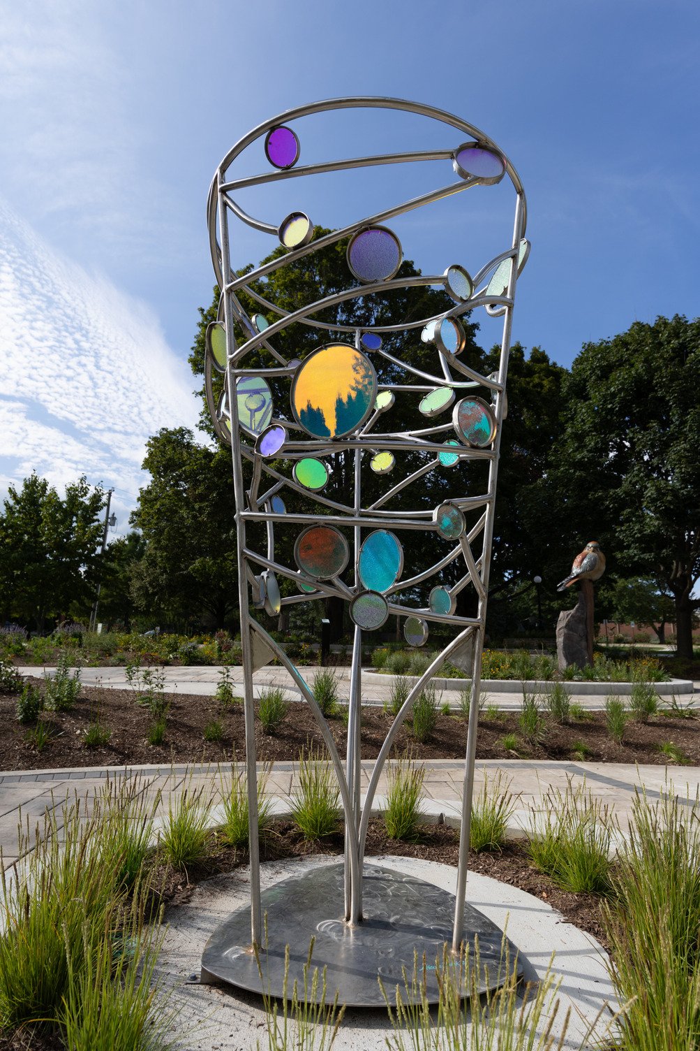an 8’ tall stainless steel sculpture with custom-laminated outdoor-grade colored, dichroic glass; the glass showcases different colors when viewed from different directions
